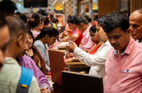 Customers purchase Gold jewelry at a store on the occasion of the festival of Dhanteras, in