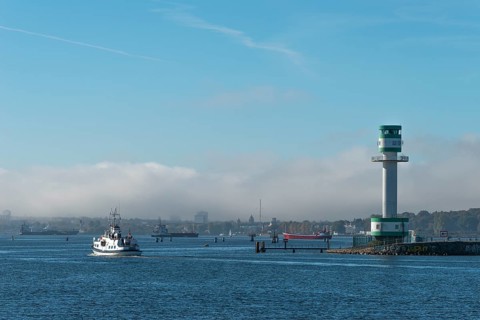 Green-white lighthouse Friedrichsort with city panorama of the state capital, Kiel Fjord, Kiel,