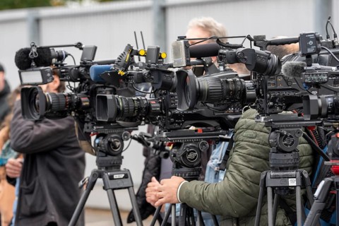 Camera crews, TV teams from various radio stations, television stations, film at a press conference