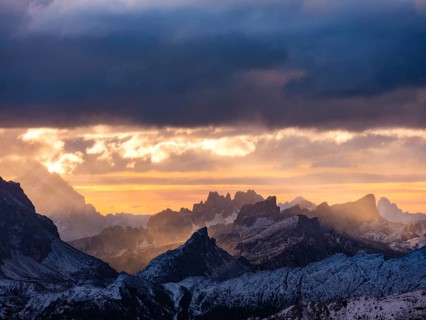 Morning light through dark clouds over the Dolomites, Alps, Belluno province, Veneto region,