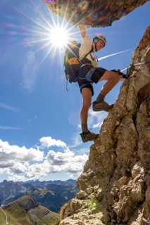 Mountaineer climbs on Ferrata Furcela de Saslonch, Langkofelscharte via ferrata, Dolomites,