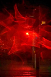 Traffic light, road traffic at night and poor visibility in a city, autumn, Germany