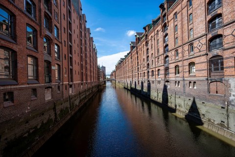 Canal between red brick buildings, warehouses in Hamburg's Speicherstadt, Hamburg, Germany