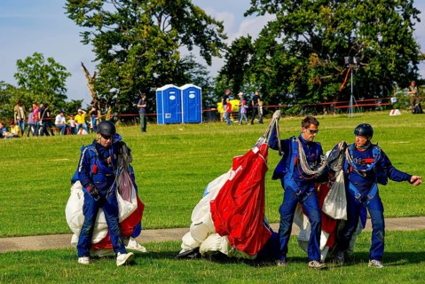 Parachutists have landed after an aerial acrobatic performance during an air show on the Rossfeld