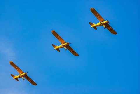 Three Piper PA-18 Super Cub aeroplanes of the Bravo Lima Formation flying in formation during an