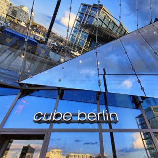 Cube Berlin, cube-shaped office building with inwardly folded glass façade reflecting the