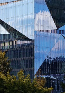 Cube Berlin, cube-shaped office building with folded glass façade reflecting the surroundings,