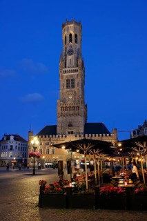 Illuminated Belfry in the historic city centre of Bruges in the evening light, Belfort and City