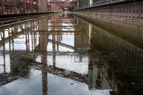 Zollverein coking plant, coke oven batteries and chimneys are reflected, water basin, UNESCO World