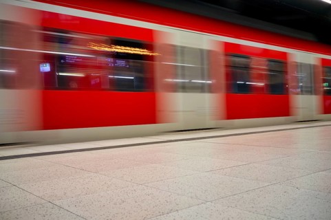 Underground arriving S-Bahn, train, class 420 in traffic red, platform, stop, station city centre,