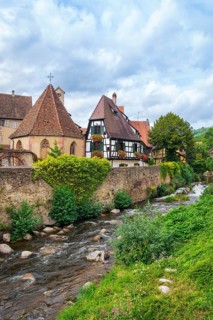 Picturesque Kaysersberg with half-timbered houses on the Weiss river in the old town centre