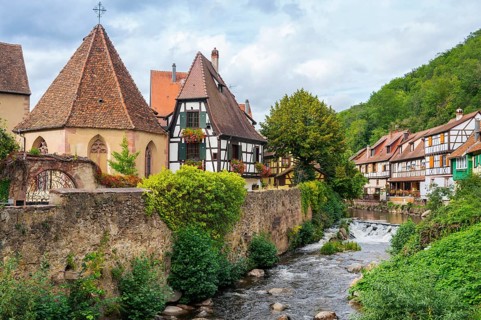 Picturesque Kaysersberg with half-timbered houses on the Weiss river in the old town centre
