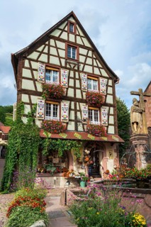 Emperor Constantin fountain in front of a half-timbered house in Kaysersberg