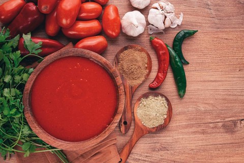Georgian sauce, Satsebeli sauce, tomato and sweet pepper sauce, with spices, in a wooden bowl,
