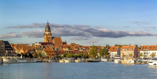 Panoramic view of the city of Waren (Müritz) with a view of the harbor from the water in sunny