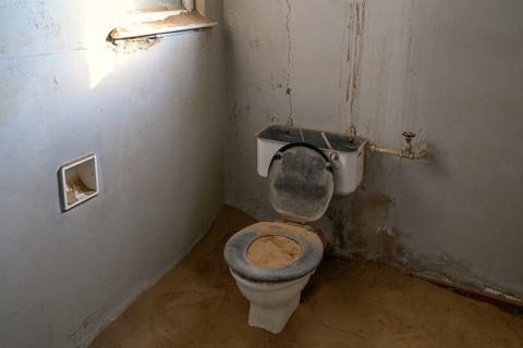 Toilet full of sand in the former hospital, Kolmanskop, restricted diamond area, Karas region,