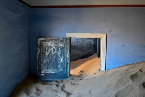 Sand mountains in a former dwelling house, interior photograph, Kolmanskop, restricted diamond