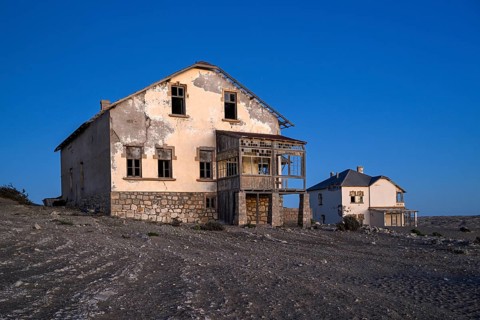 Dilapidated buildings in the desert sand, blue hour, Kolmanskop, near Lüderitz, Karas region,