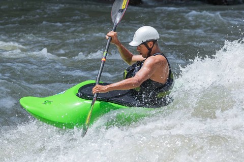 Young man kayaking in river, Costa Rica, Central America