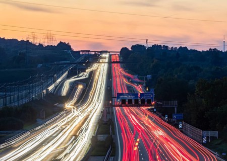 Motorway near Stuttgart with several lanes in the evening with sunset. Heavy traffic with light