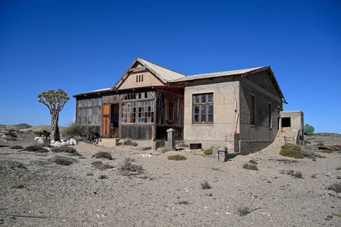 Dilapidated building in the desert sand, Pomona, restricted diamond area, near Lüderitz, Karas