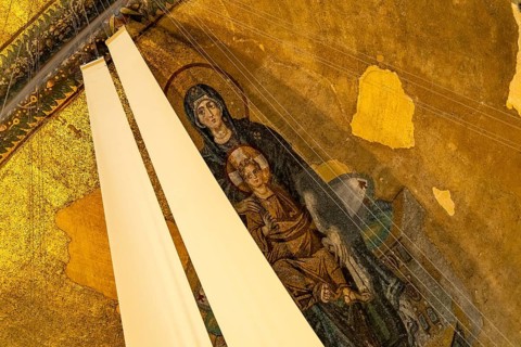 Mosaic with the Madonna and Child partially covered with fabric in the apse of the present-day