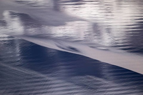 Light and shadow on gentle waves form structures on the sea surface in a bay, Otroya or Otrøya