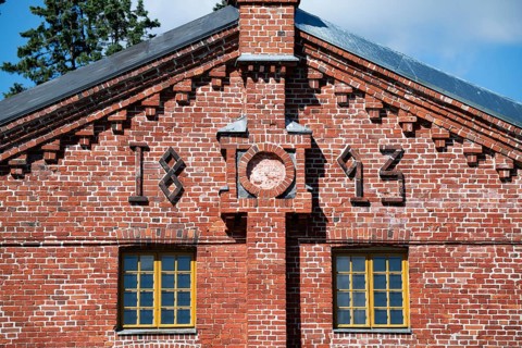 Brick façade with inscription 1893, former paper factory and mill for the production of groundwood
