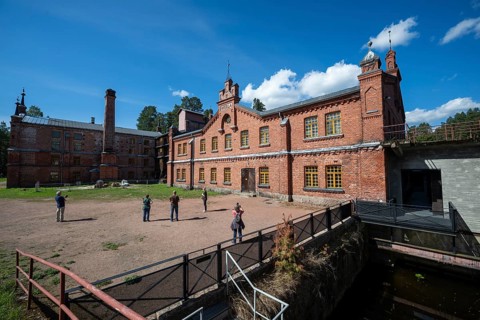 Visitors in front of the former paper mill and groundwood pulp board mill, UNESCO World Heritage