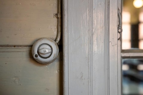 Old light switch on wooden wall, former paper factory and mill for the production of groundwood