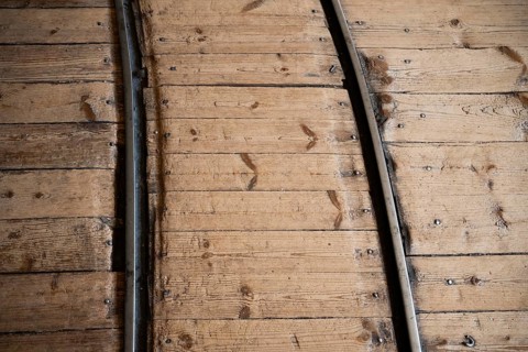 Rails for transporting cardboard, former paper factory and mill for the production of groundwood