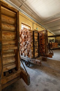 Carts with sawn logs for further processing, former paper factory and mill for the production of