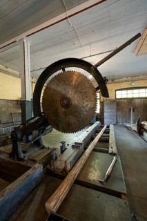 Large historic circular saw and log, former paper factory and mill for the production of groundwood