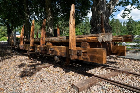 Railway tracks and wagons on rails for timber transport, former paper factory and mill for the