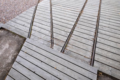 Rails for timber transport, former paper mill and mill for the production of groundwood pulp board,