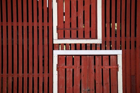 Falun red painted wooden slats of a barn, former paper factory and mill for the production of