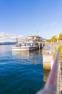 Ship in the harbour under a clear sky on calm water, Überlingen, Lake Constance, Germany