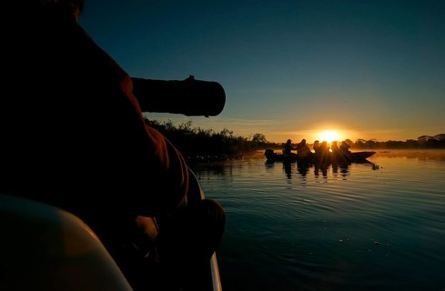 Wildlife photographers in a boat on a river in the Pantanal, Brazil