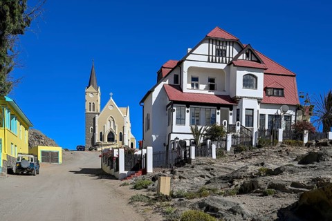 Colonial house facade in the Kirchstraße, in the background the rock church, Lüderitz, Karas