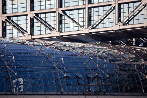 Three male glass cleaners cleaning a glass roof at Berlin Central Station, Berlin, Germany