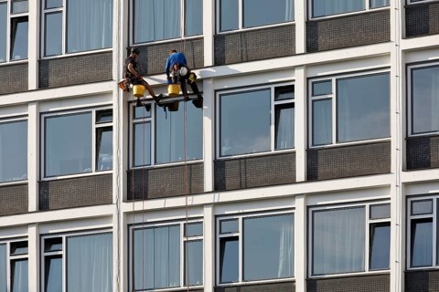Two male glass cleaners abseiling down the hotel façade to clean windows, aletto Hotel Kudamm,