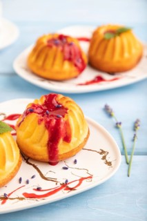 Semolina cheesecake with strawberry jam, lavender, cup of coffee on blue wooden background. side