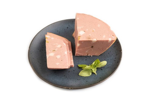 Mortadella sausage on plate with pepper and herbs isolated on white background. Side view