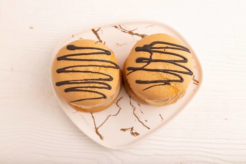Caramel Cream Cakes on white wooden background, top view, flat lay, close up