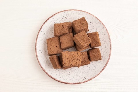 Chocolate marshmallow on white wooden background. top view, flat lay, close up