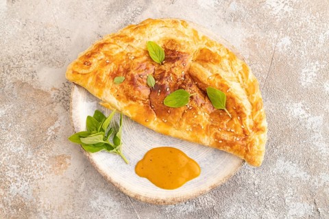 Fried homemade Khachapuri cake with cheese and meat, fried in pan. Traditional Georgian cuisine on