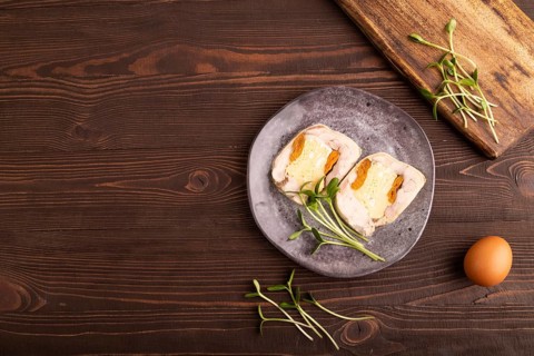 Chicken, egg and dried apricot meatloaf, microgreen on brown wooden. Diet, healthy eating. top