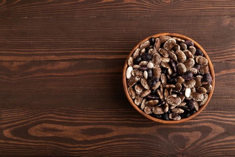 Wooden bowl with Kidney beans on brown wooden background, top view, flat lay, copy space,