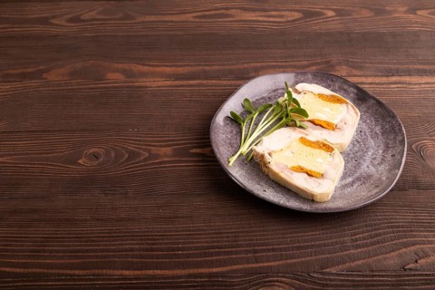 Chicken, egg and dried apricot meatloaf, microgreen on brown wooden. Diet, healthy eating. side