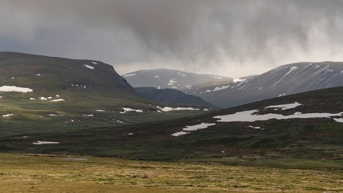 Lonely plateau with snowfields, low clouds, Kongevegen or King's Road, Olavsleden pilgrimage route,